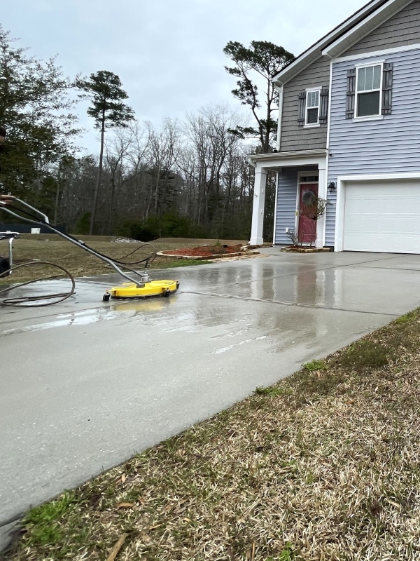 J&J Earthworks LLC tech washing concrete for Mount Pleasant area driveway.