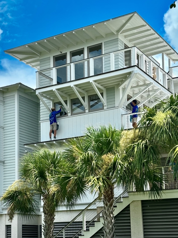 J&J Earthworks LLC washing windows for Mount Pleasant area building.